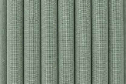 A close-up of vertically pleated fabric in a muted sage green color, showing the woven texture and soft shadows between the folds.