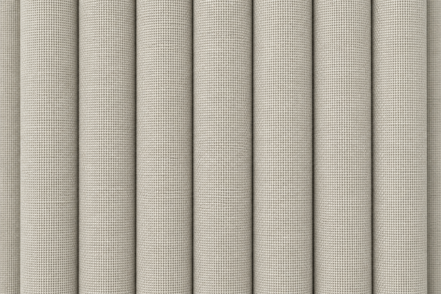 Close-up of a light beige woven fabric or wallpaper texture shown in vertical rolled panels.
