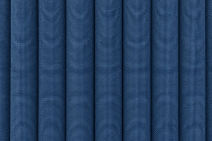 A close-up of blue textured fabric with vertical pleats or folds filling the frame.