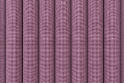 A close-up of pleated fabric with a fine woven texture in a muted dusty mauve or lavender-purple color.