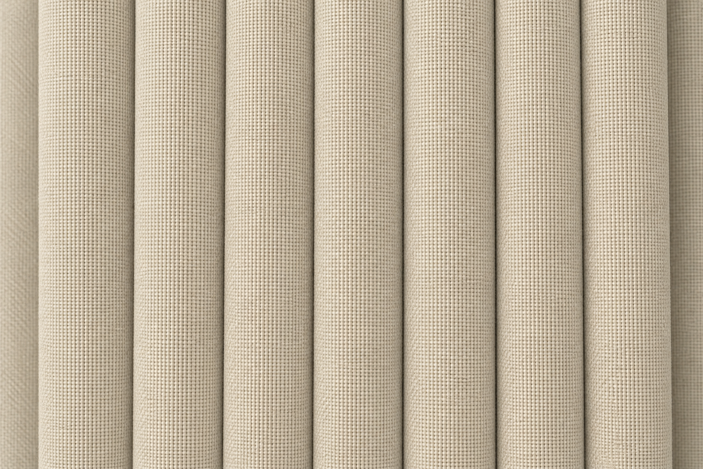 Close-up of a beige woven fabric with a textured basketweave pattern, shown in vertical folds.
