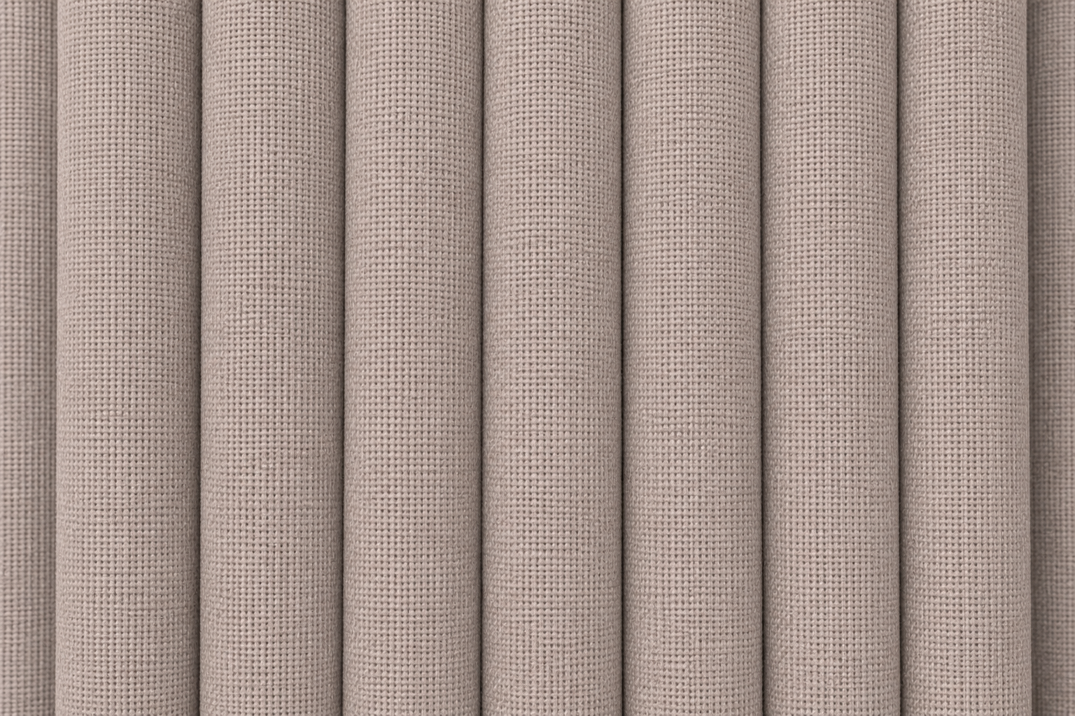 Close-up of a textured fabric or wallpaper pattern with vertical pleated folds in a warm taupe-beige color.