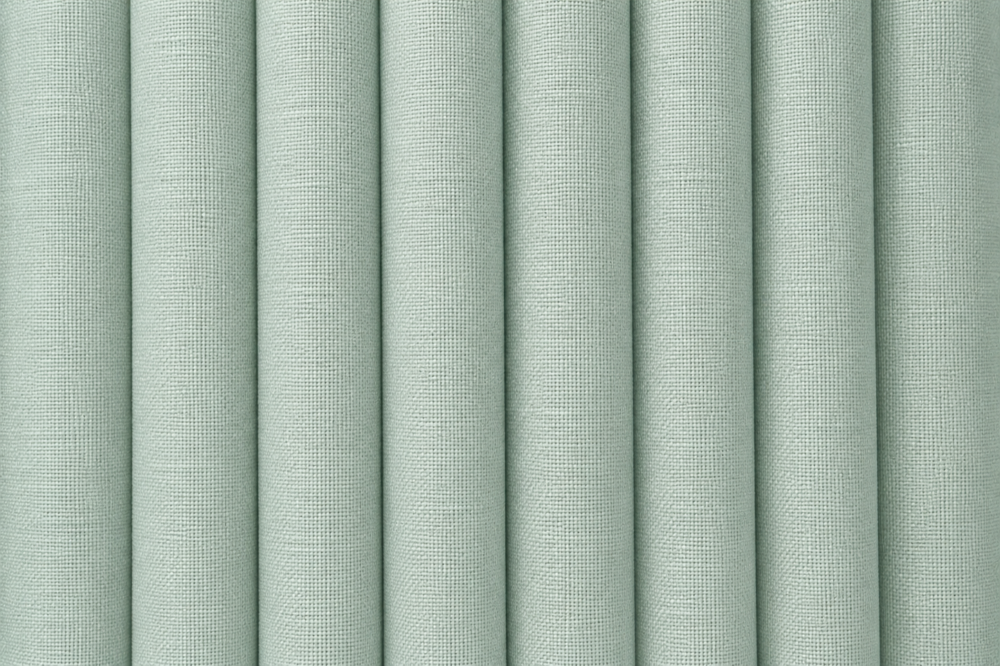 A close-up of vertically pleated fabric or wallpaper in a pale sage green color, showing a fine woven texture.