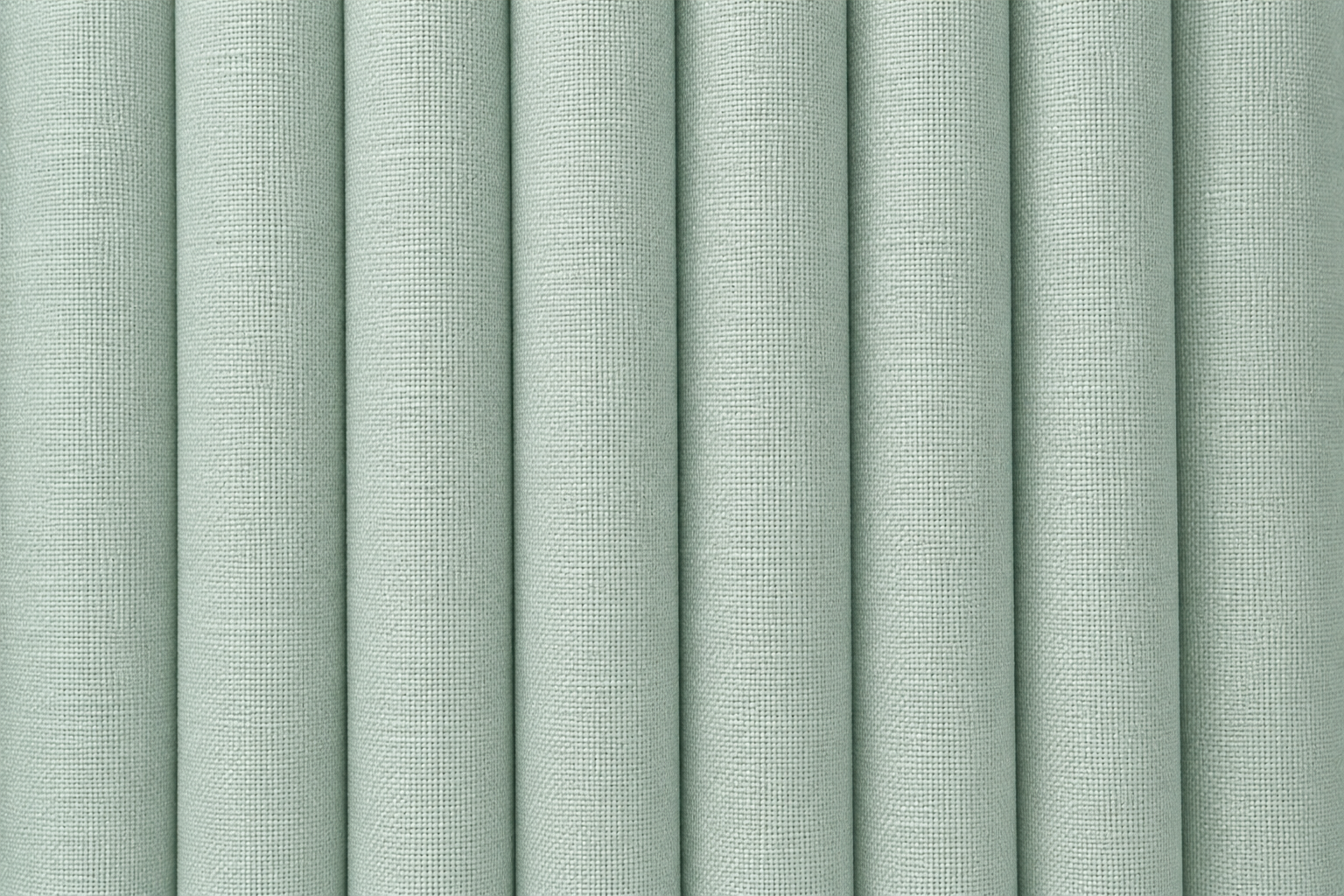 A close-up of vertically pleated fabric or wallpaper in a pale sage green color, showing a fine woven texture.