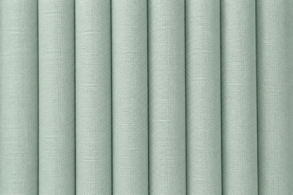 A close-up of vertically pleated fabric or wallpaper in a pale sage green color, showing a fine woven texture.