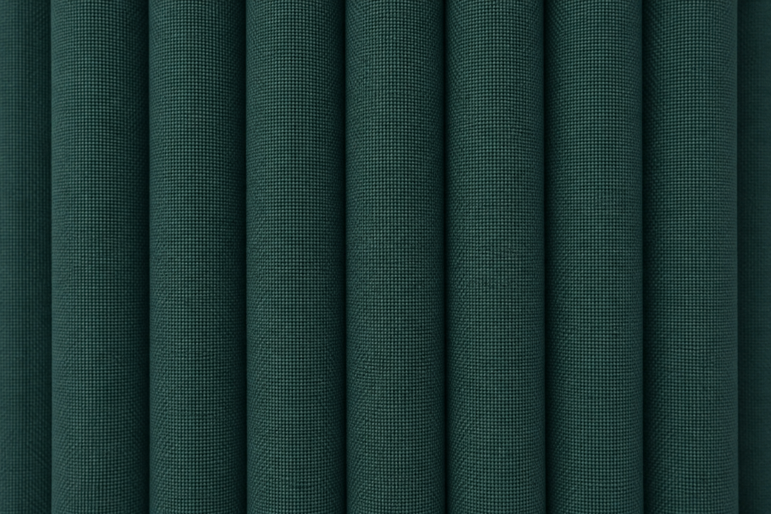 Dark green textured fabric with vertical pleats or folds filling the frame.